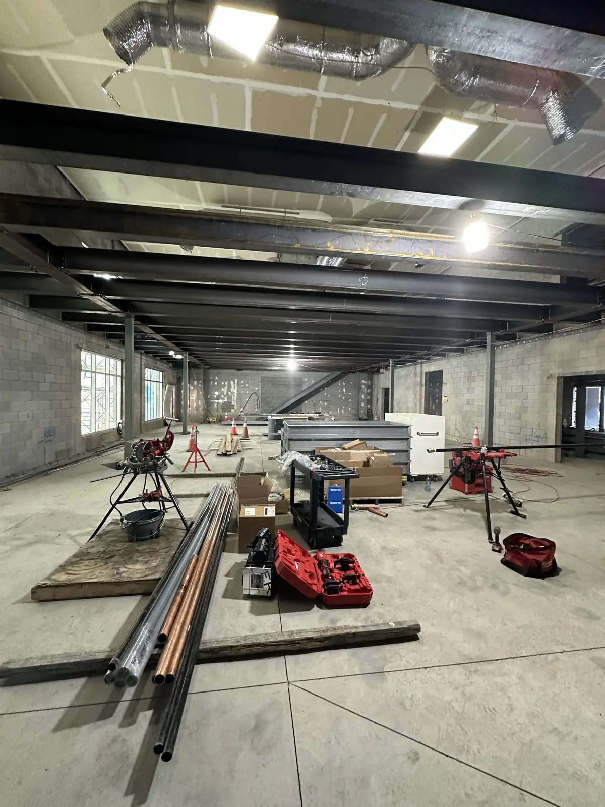 Commercial pipe threading equipment set up on an active construction site